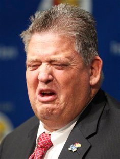Kansas football coach Charlie Weis reacts while answering a question during a news conference in Lawrence, Kan., Friday, Dec. 9, 2011. Weis says that Kansas offered him an opportunity too good to pass up: The chance to rebuild a long-suffering program and mend his own tarnished reputation.(AP Photo/Orlin Wagner)